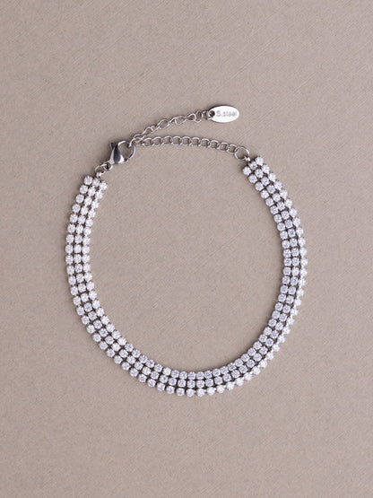 Silver beaded bracelet on a beige background