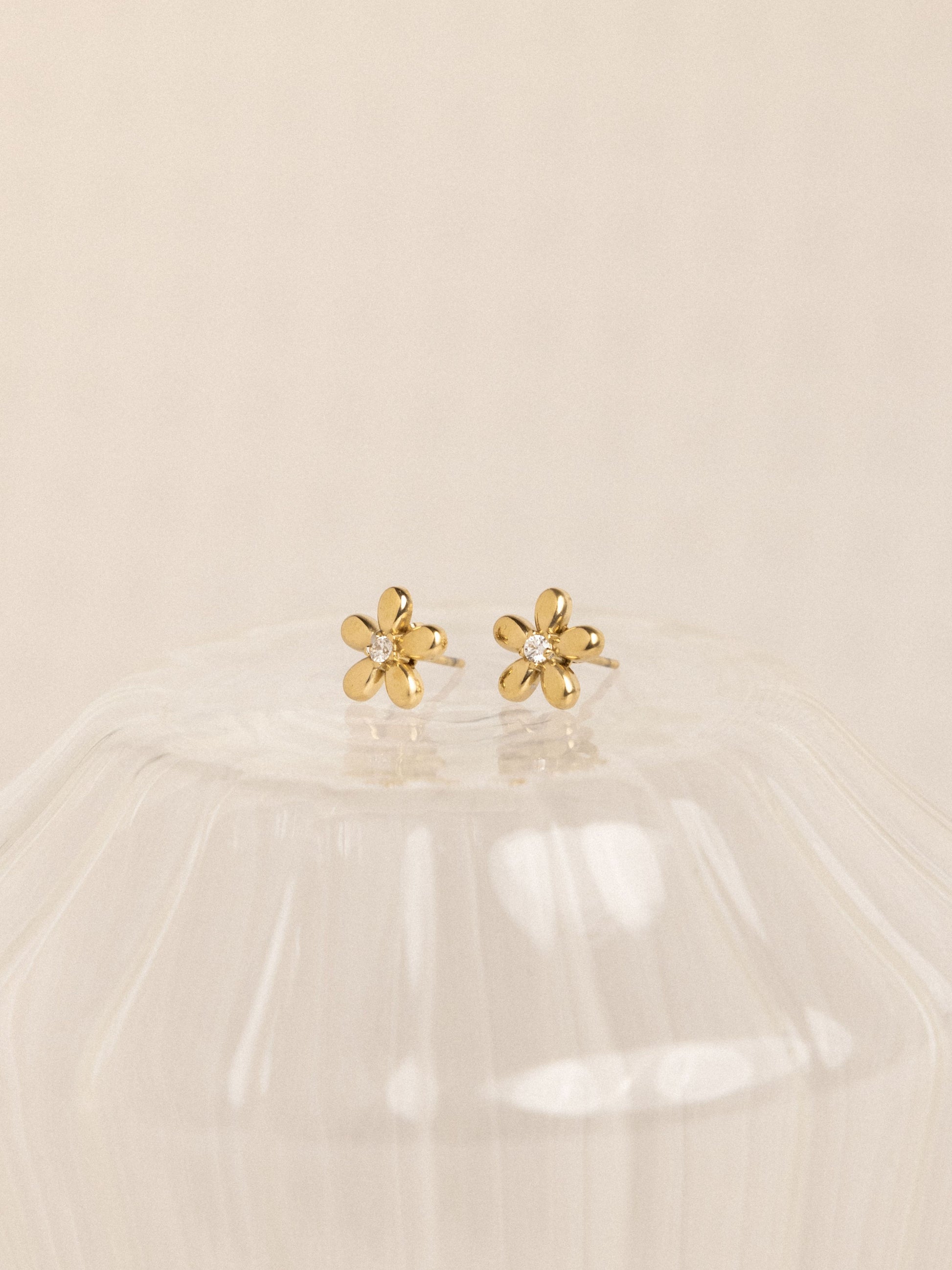 18k gold-plated flower earrings on beige background