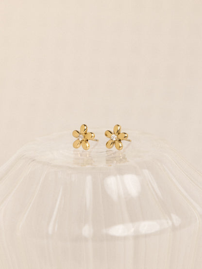 18k gold-plated flower earrings on beige background