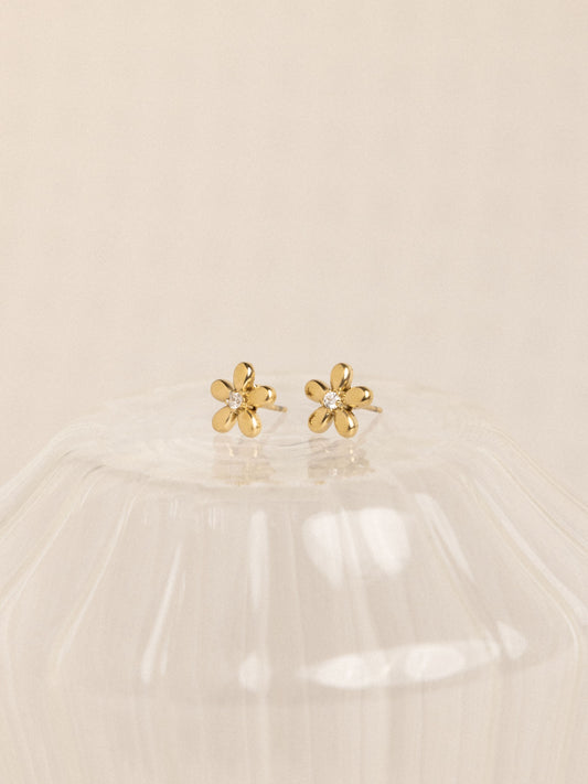18k gold-plated flower earrings on beige background