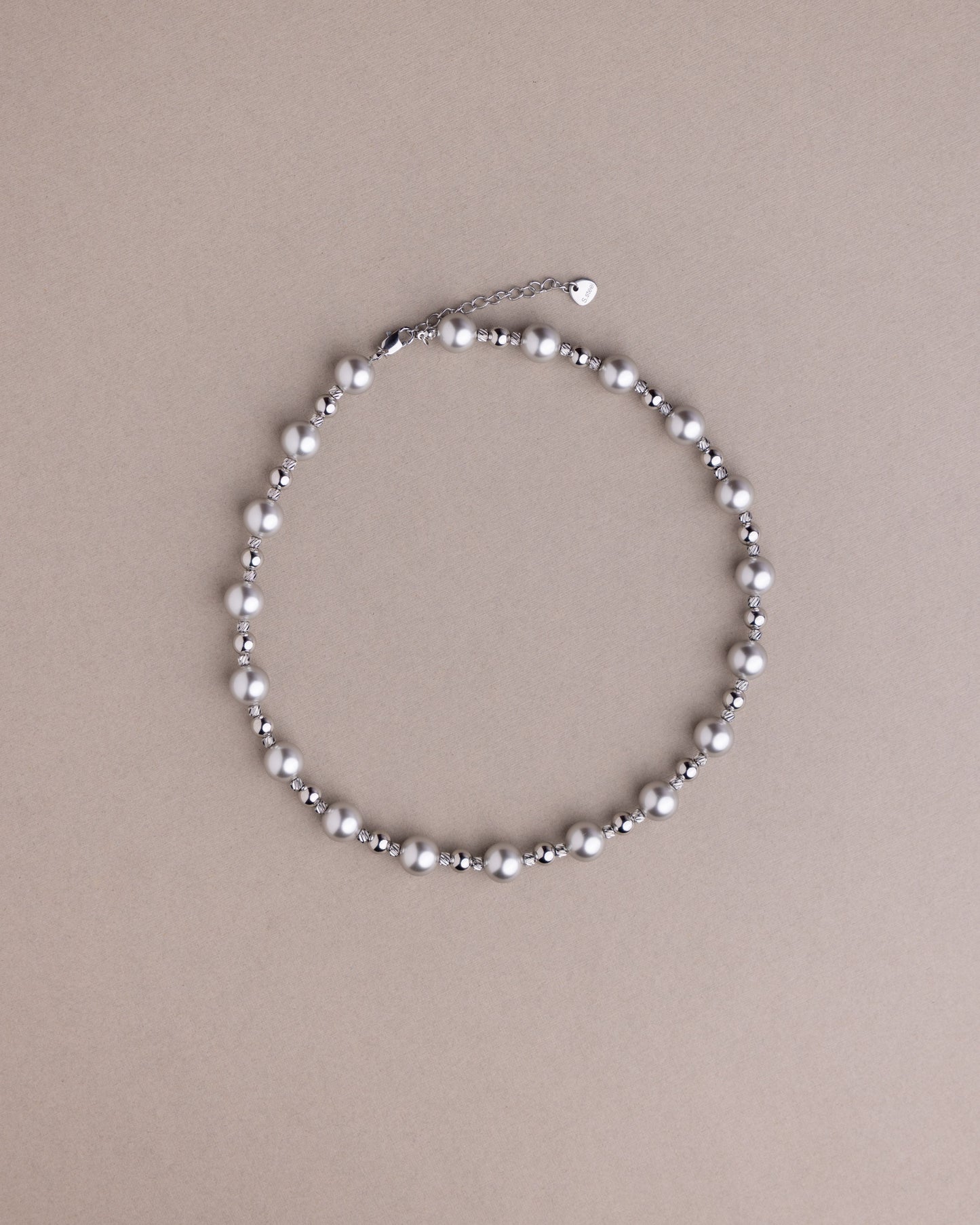 Pearl necklace on a beige background