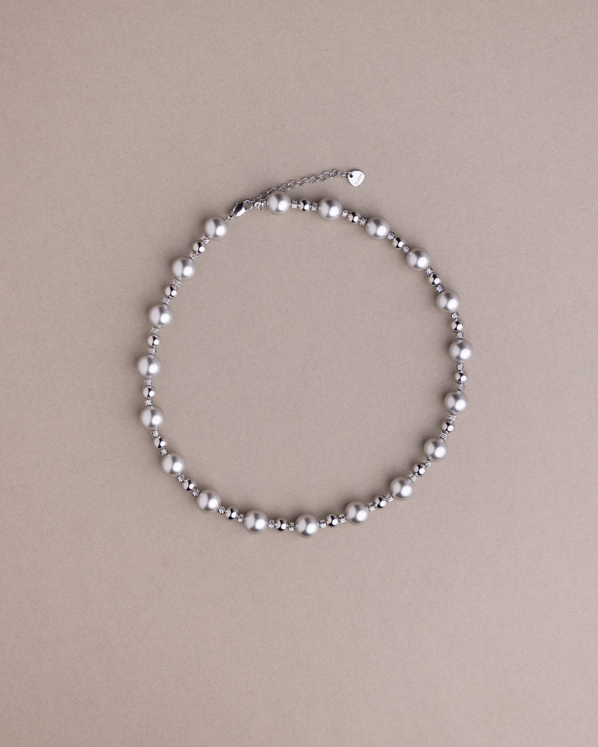 Pearl necklace on a beige background