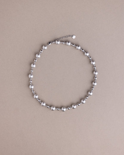 Pearl necklace on a beige background